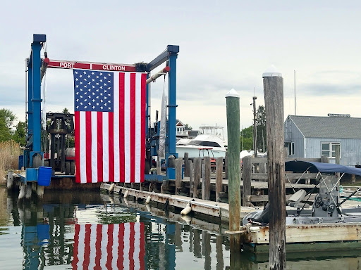 Large American flag displayed beneath the Port Clinton boat lift at Petzold’s Port Clinton Marina in Clinton, CT.