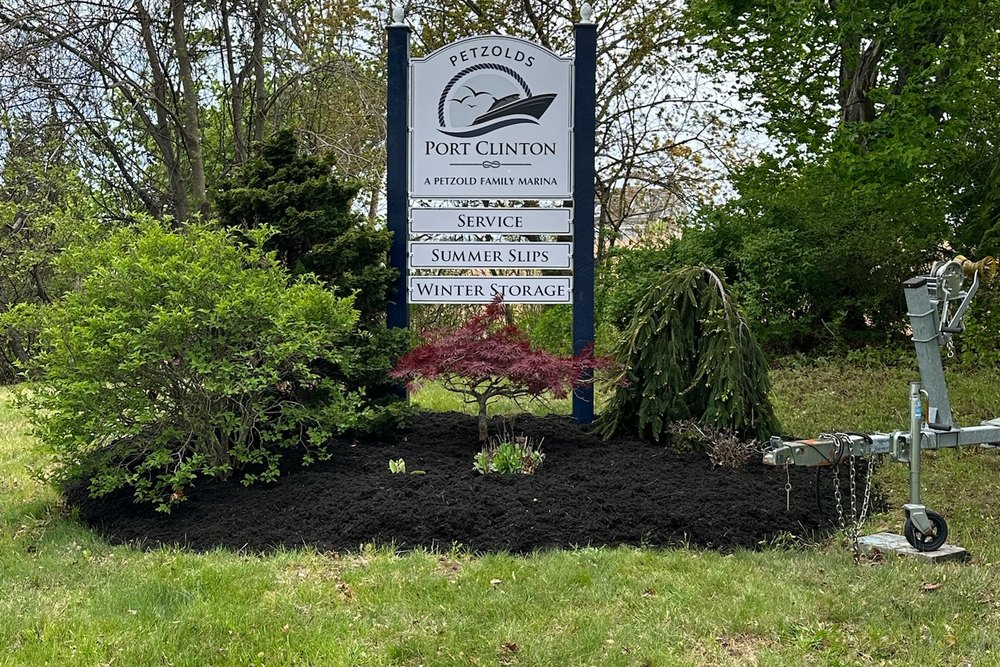 The Petzold's Port Clinton Marina entrance sign surrounded by planting