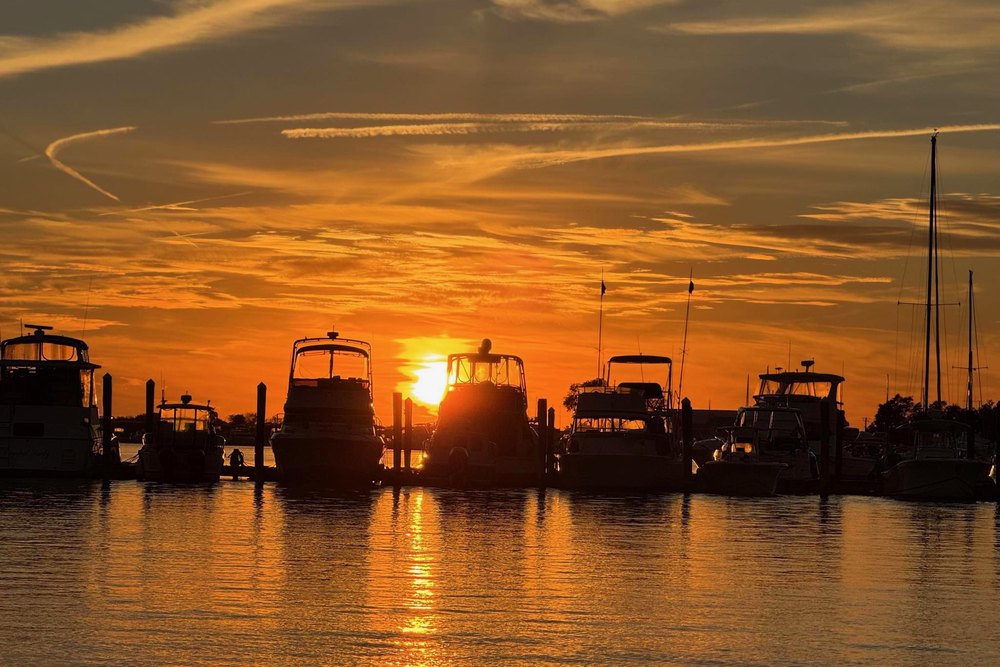 Sunset over the docks and moored boats at Petzold's Port Clinton Marina