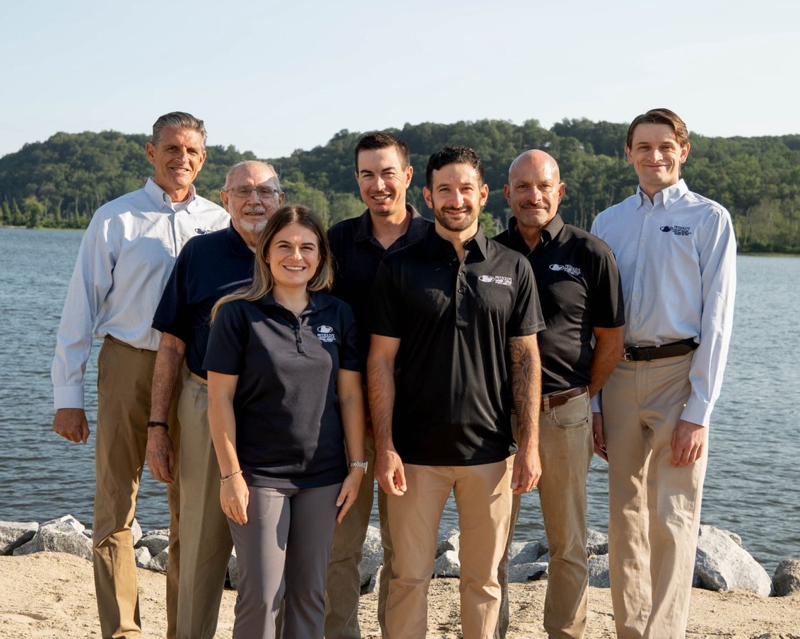 The Petzold's team standing on the shoreline