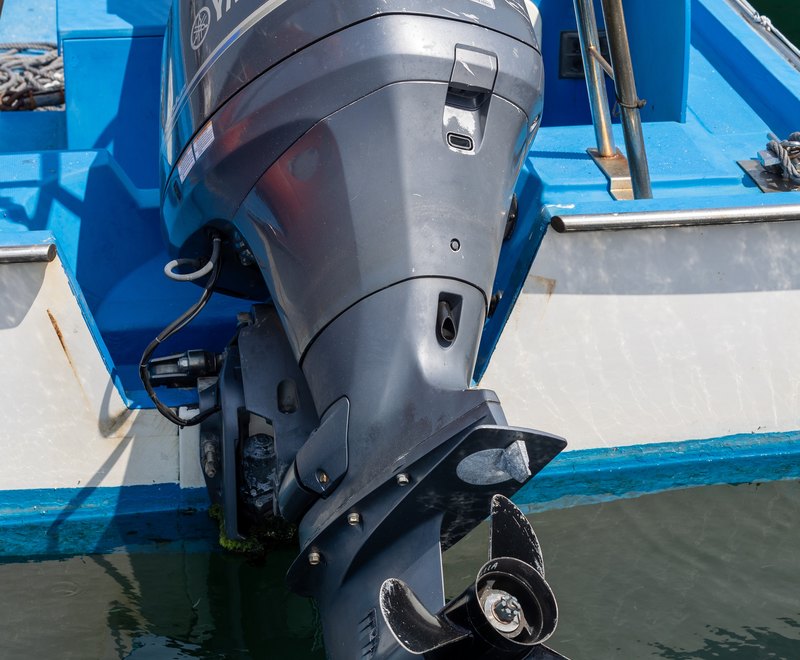 A Yamaha outboard engine mounted on the transom of a boat at the dock